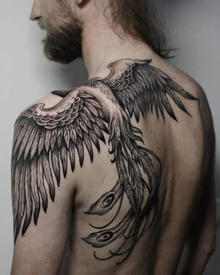 7sinstattoo.pl Osoba z długimi włosami pokazuje plecy, odsłaniając skomplikowany tatuaż dużych, szczegółowych skrzydeł ptaka, które rozciągają się od jej ramion. Tatuaż, nazwany DSC05558 i wykonany w najlepszym studio tatuażu Poznań, zawiera również pióra z wzorami przypominającymi oczy, przypominającymi pióra pawia. Najlepsze studio tatuażu Seven Sins Tattoo